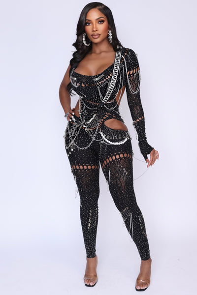 Front view of the Risque Affair Cutout Mesh Jumpsuit with rhinestones, cutouts, and one-sleeve design.