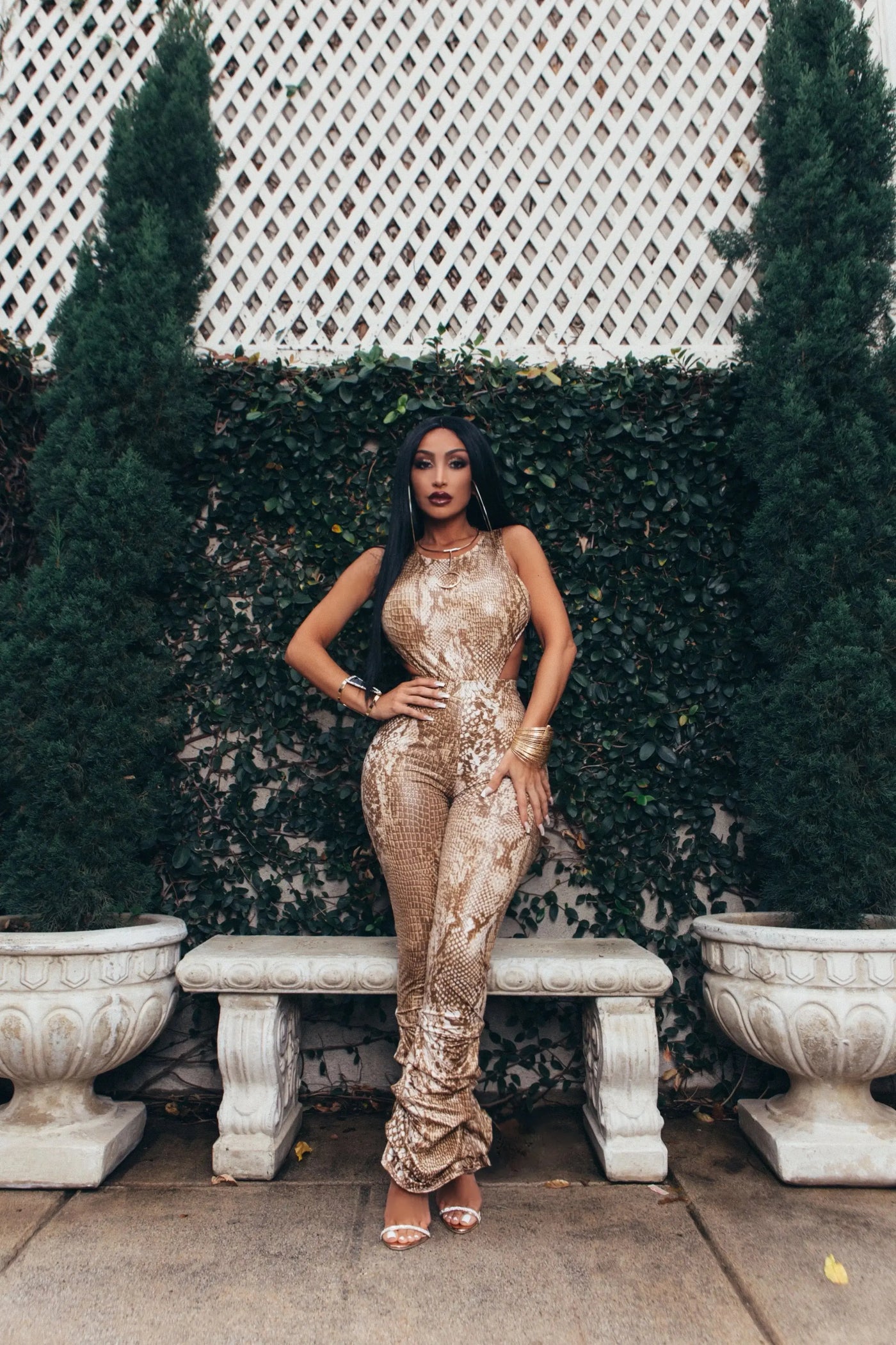 Model wearing the Saturday (Snake) two-piece set, showcasing a snake print leotard paired with high-waisted ruffled bell-bottom pants that elongate the legs and add dramatic flair.