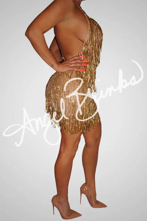 Side profile of the rhinestone chain trim fringe, showing the intricate gold embellishments over the nude mesh fabric.