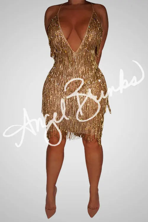 Model wearing the SNAPPED (GOLD) midi dress, featuring a deep V neckline, nude mesh base, and gold rhinestone chain fringe that sparkles under light.