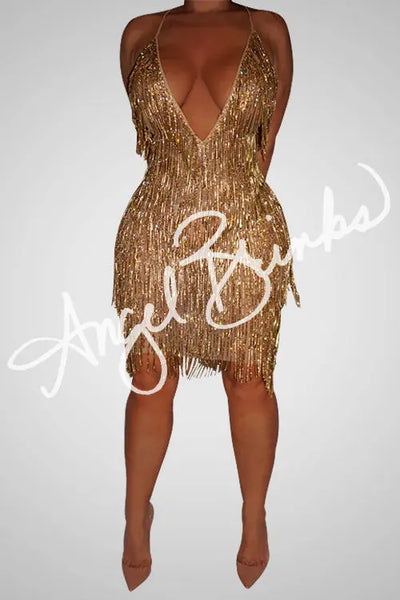 Model wearing the SNAPPED (GOLD) midi dress, featuring a deep V neckline, nude mesh base, and gold rhinestone chain fringe that sparkles under light.