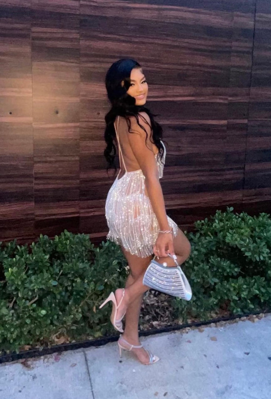 Close-up of gold rhinestone chain fringe on nude mesh fabric of Stadium Status mini dress.