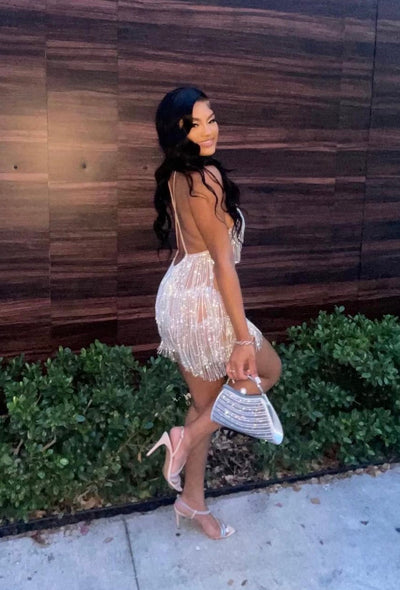 Close-up of gold rhinestone chain fringe on nude mesh fabric of Stadium Status mini dress.