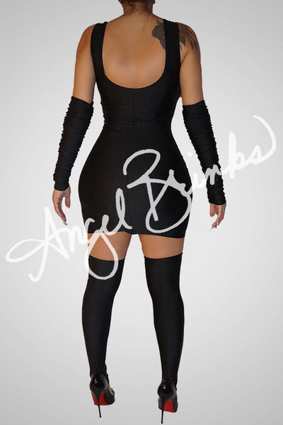 Back view revealing the zipper-free design and clean lines of the mini dress, with matching sleeves and thigh-highs completing the bold look.